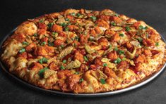 Large Nashville Hot Chicken Pizza topped with three-cheese blend, pickles and green onions